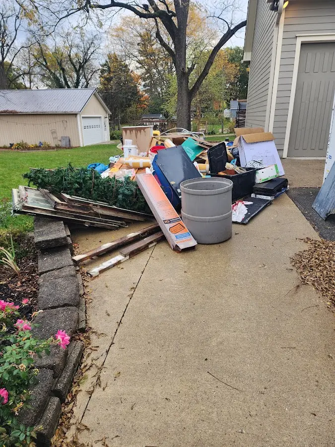 Dumpster being loaded with debris for Estate Cleanout Dumpster Rental in Poplar Grove